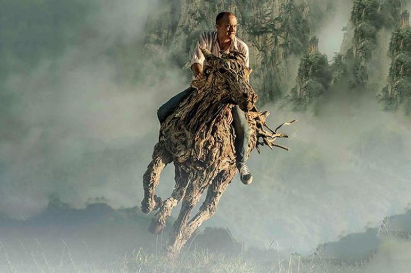Mains d’artiste assemblant des morceaux de bois flotté pour une nouvelle sculpture